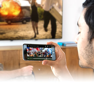 young men watching AirTV on phone and TV