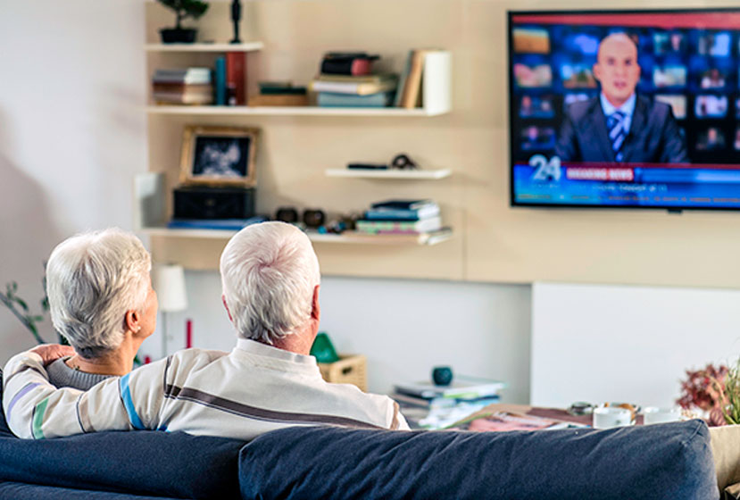 Couple at home watching Sling using the AirTV Player