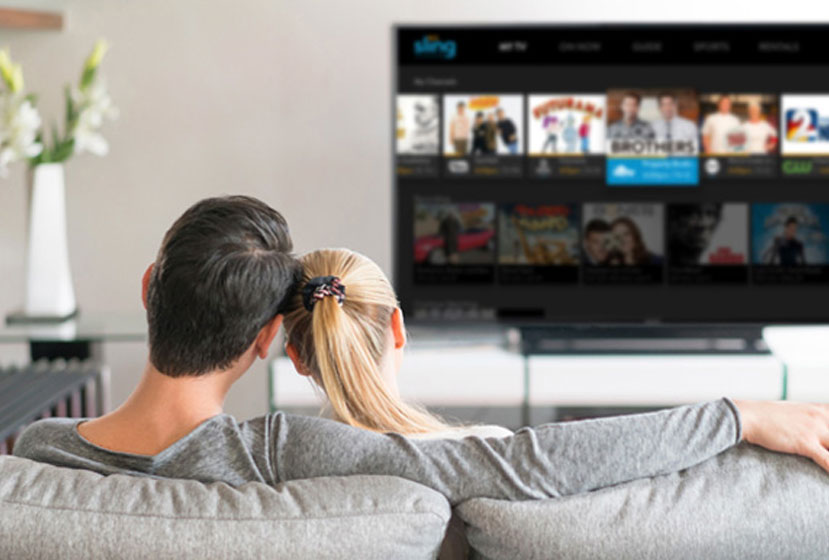 Couple at home watching Sling using the AirTV Player